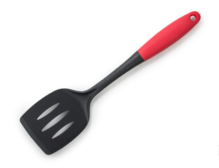 Black plastic kitchen spatula with red handle isolated on a white background. Top view, close up.