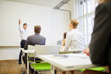 Business people listening to a lecture