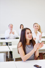 Young businesswoman applauding