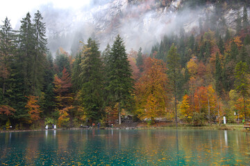 Scenic landscape view of blue lake in Autumn. Crystal clear lake of Blausee Switzerland