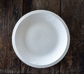 empty white plate on wooden