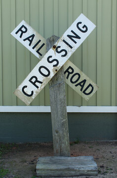 old Railroad crossing sign on wooden post