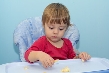 Baby boy eating cheese pie - gibanica