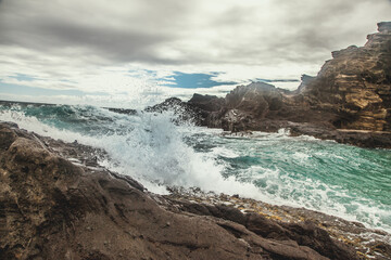 Fototapeta na wymiar Waves crashing or rocks in hawaii