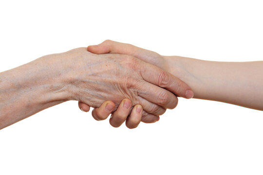 Handshake between an old person with a wrinkled hand and a kid, isolated on white background