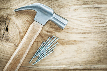Claw hammer nails on wooden board building concept