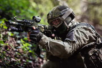 Soldier takes aim in forest