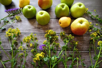 Fresh fruit apples and pears on a brown background