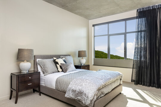 Comfortable modern bedroom with daylight view window.