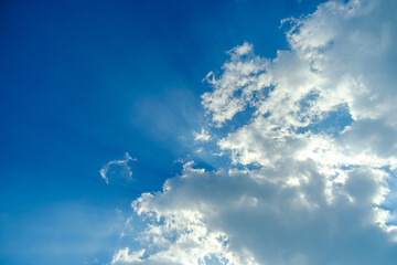 Crepuscular light with white clouds on blue sky
