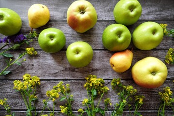 Fresh fruit apples and pears on a brown background