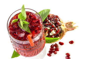 Natural cold pomegranate juice in a glass top