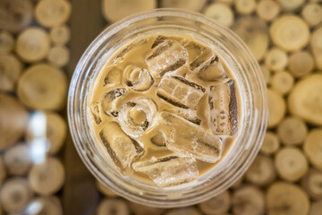 Iced coffee in take away plastic glass, closeup, top view