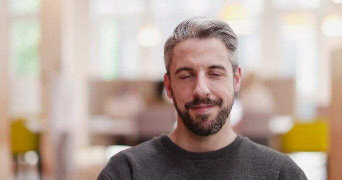 Portrait of male entrepreneur in a modern shared workplace