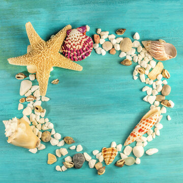Starfish, shells, and pebbles forming frame for copyspace