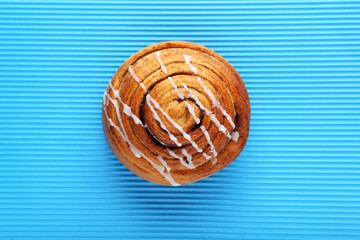 Cinnamon bun on blue background