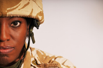 Half face portrait of black woman wearing British military Gulf War uniform.