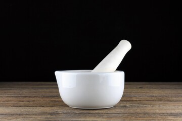 White porcelain mortar and pestle for mixing medicine in the pharmacy.