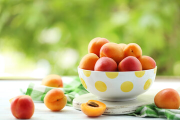 Ripe apricots fruit on white wooden table