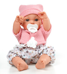 Toy doll child, in pink blouse with pacifier on isolated background