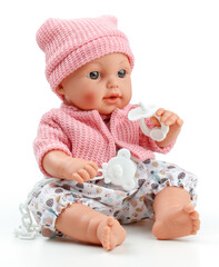 Toy doll child, in pink blouse with pacifier on isolated background