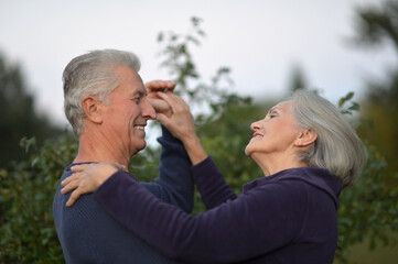 senior couple dancing outdoors