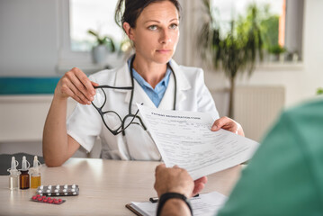 Doctor receiving patient registration form