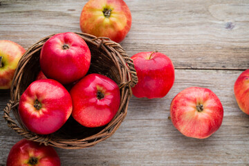 Ripe red apples on wooden background.