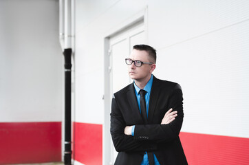 handsome portrait of a businessman, director or manager with crossed arms close up