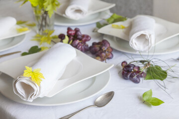 Table setting for lunch or dinner with guests,white tones