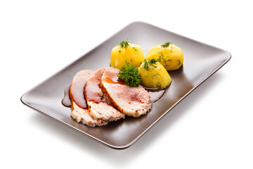 Roast pork chop steaks with potatoes on white background