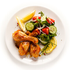 Roast drumsticks on white background