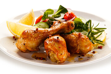 Roast drumsticks on white background