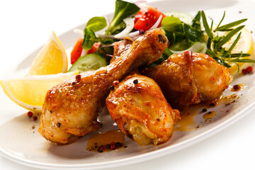 Roast drumsticks on white background