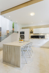 Kitchen with countertop and bar stools