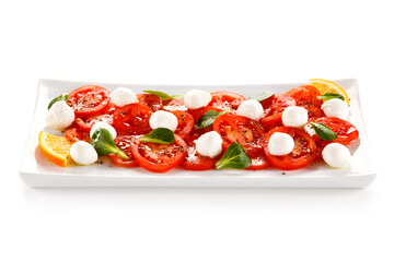 Caprese salad - mozzarella and tomatoes on white background