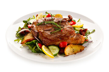 Grilled chicken fillet with vegetables on white background