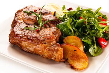 Grilled beefsteak with vegetables on white background