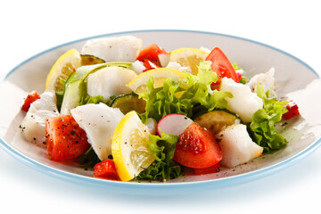 Salad with grilled fish fillet on white background
