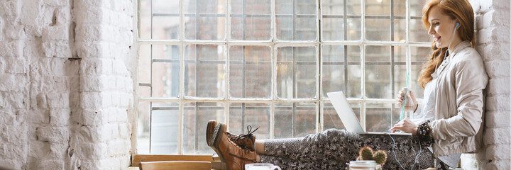 Woman sitting on window sill