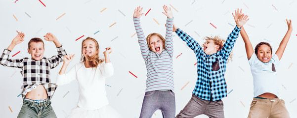 Cheerful girls and boys jumping © Photographee.eu