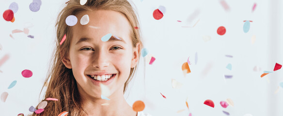 Smiling young girl with confetti