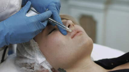 Injections of hyaluronic acid in the lips in the beauty salon