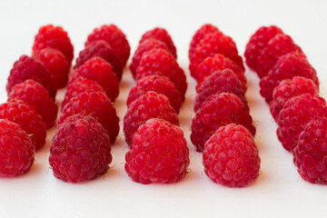 raspberry is laid in a row on a white background.