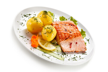 Roast salmon with potatoes on white background
