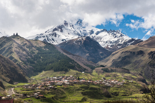 Kazbegi mountain with peak hidden in clouds