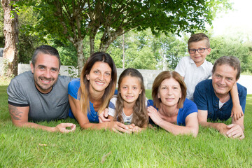 family of six 6 lying on the grass happy and cheerful