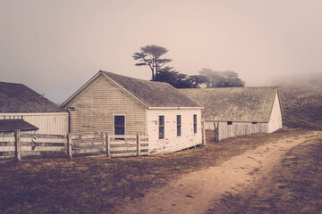 White farmer houses on background of fog. Easy toning