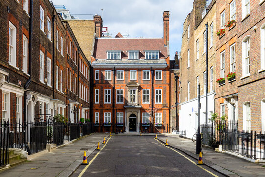 Typical street scene in the central London district with familiar architecture facades to urban housing.