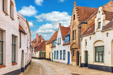 Fototapeta na wymiar Vintage street in Bruges Belgium with blue sky and white cloud.